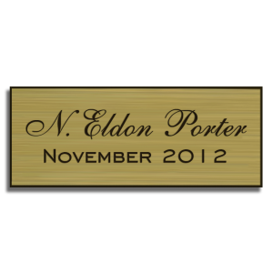 gold perpetual plaque insert with black text and double-sided mounting tape on back