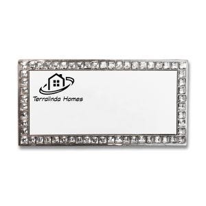 Rhinestone bordered name tag with printed company logo.